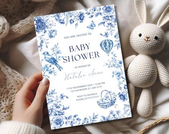 May include: Blue and white baby shower invitation with a floral design. The invitation says "You are invited to Baby Shower in honor of Natalie Anne" and includes the date, time, and location of the event.