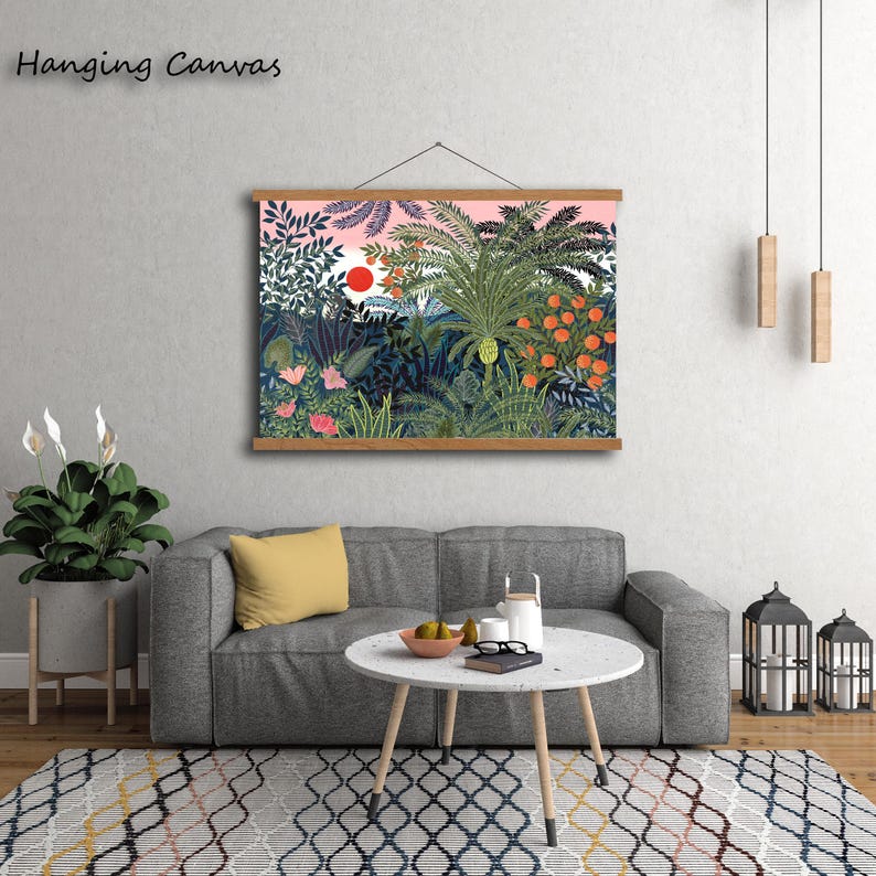 May include: A hanging canvas print featuring a vibrant jungle scene with lush green foliage, orange fruits, and a red sun against a pink sky. The text "Hanging Canvas" is at the top left.