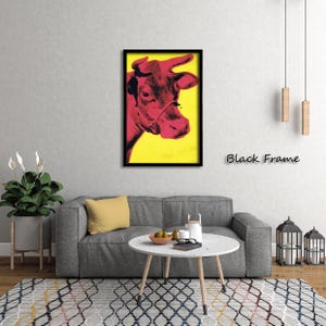 May include: A framed pop art print featuring a red cow's head against a yellow background. The cow is in profile, with a black frame. The text "Black Frame" is below the artwork.