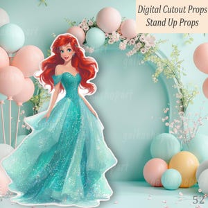 A digital cutout prop of a Mermaid princess in a teal gown with red hair. The image includes a background of balloons and floral arrangements. Text reads "Digital Cutout Props Stand Up Props."