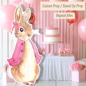 Puede incluir: Un recorte de acuarela de un conejito con una chaqueta y un lazo rosas, frente a un telón de fondo rosa para una fiesta. El telón de fondo incluye una tarta de dos pisos, globos y el texto "Cutout Prop / Stand Up Prop" y "Digital files".
