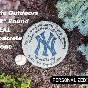 May include: A 12-inch round concrete stone with a personalized message and a New York Yankees logo. The stone is surrounded by mulch and a baseball.