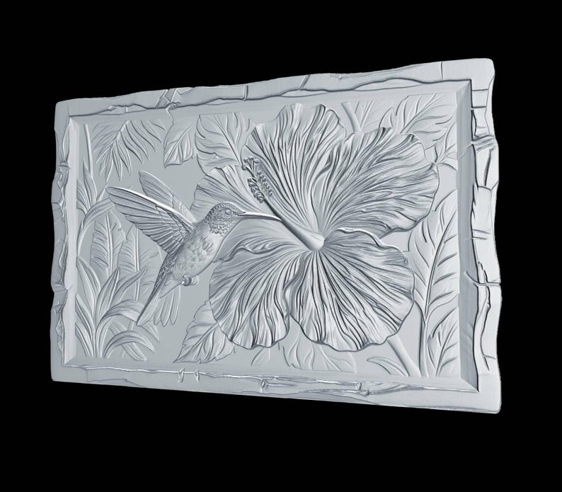 May include: A rectangular white wall plaque featuring a high-relief carving of a hummingbird hovering near a large hibiscus flower. The design includes detailed foliage in the background and a textured, uneven border framing the central scene.