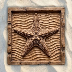 May include: A square wooden wall plaque featuring a carved starfish centered over a background of horizontal wavy lines. The piece is crafted from medium-brown wood with a visible grain and a textured, rustic frame surrounding the central design.