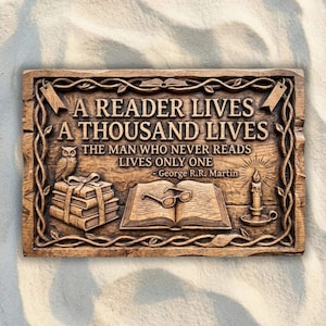 May include: A rectangular brown wooden plaque featuring carved text that reads A READER LIVES A THOUSAND LIVES THE MAN WHO NEVER READS LIVES ONLY ONE - George R.R. Martin. The design includes an owl, a stack of books, an open book, and a candle.