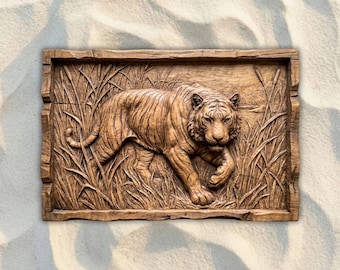 May include: A rectangular, wooden relief carving of a tiger walking through tall grass. The tiger is carved in detail, with visible stripes and fur texture. The frame is also carved, giving the piece a rustic, natural look.