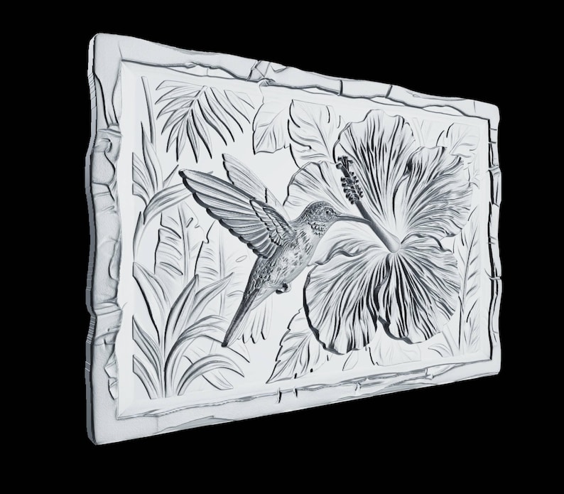 May include: A rectangular white wall plaque featuring a detailed relief carving of a hummingbird hovering near a large hibiscus flower, surrounded by tropical foliage. The piece is framed by a textured border with a carved bamboo-like appearance.