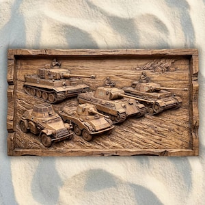 May include: A wooden relief carving depicting several detailed military tanks. The tanks are carved in a realistic style, with visible treads, turrets, and gun barrels. The artwork is set within a rectangular frame, showcasing a scene of military vehicles.