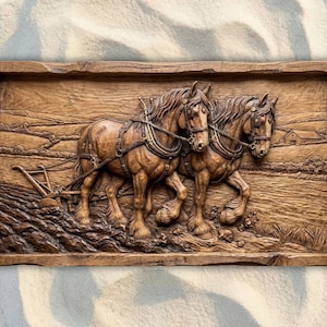 May include: A detailed wooden relief carving depicting two draft horses pulling a plow across a field. The horses are harnessed and the scene includes a farmhouse and plowed earth, all within a rustic frame.