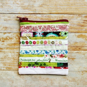 Selvage edge wallet purse carry-all zipper pouch upcycled reused cotton fabric selvage edges patchwork quilted multicolor texts kid mom gift