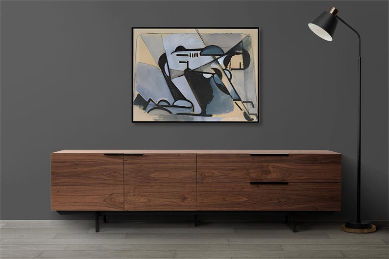 May include: A framed abstract painting with geometric shapes in shades of blue, black, and white on a beige background. The painting is hanging on a gray wall above a wooden cabinet with black metal legs.
