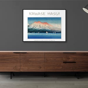 May include: A framed print of a Japanese woodblock print depicting a mountain range with a red and pink peak, a body of water, and a few small boats. The print is titled "Kawase Hasui" and includes the text "Collection of Alexandre Bergougnan of the Fuji Art".