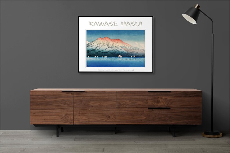 May include: A framed print of a Japanese woodblock print depicting a mountain range with a red and pink peak, a body of water, and a few small boats. The print is titled "Kawase Hasui" and includes the text "Collection of Alexandre Bergougnan of the Fuji Art".