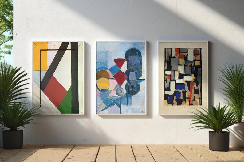 May include: Three framed abstract paintings with geometric shapes and colors. The paintings are in white frames and are hanging on a white wall.