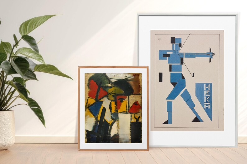 May include: Two framed abstract art prints. The print on the left is a colorful geometric design with red, yellow, blue, and black. The print on the right is a blue and white geometric design with the word "HEKA" in black.
