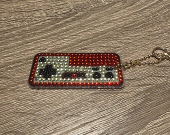 Llavero de doble cara con mando de juego