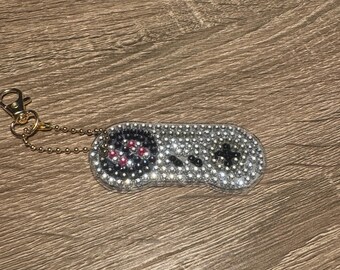 Llavero de doble cara con mando de juego