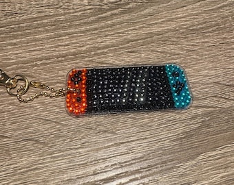 Llavero de doble cara con mando de juego