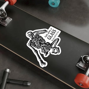 May include: A black and white sticker showing a skeleton holding a sign that says "Cash, grass, or GLASS" and "No one melts for free." The skeleton is in a dynamic pose. The sticker is on a black surface.