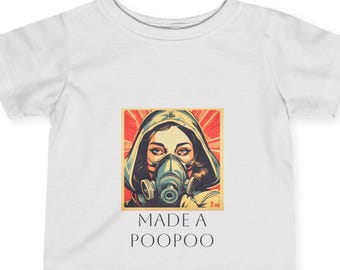 May include: White t-shirt with a graphic of a woman wearing a gas mask and the text "MADE A POOPOO".