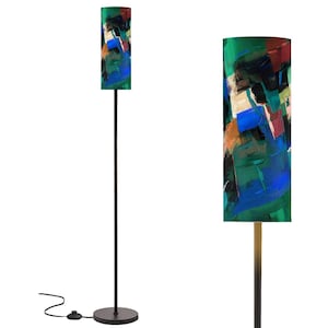 May include: A modern floor lamp with a cylindrical shade featuring an abstract painting in shades of green, blue, black, and orange. The lamp has a slender, dark metal pole and a round base. The shade is approximately 12 inches in diameter and 60 inches tall.