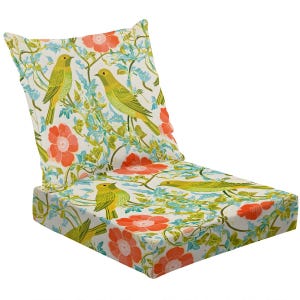 May include: Outdoor chair cushion with a floral and bird pattern. The cushion features yellow birds, red flowers, and green vines on a white background. The design is printed on the seat and backrest.