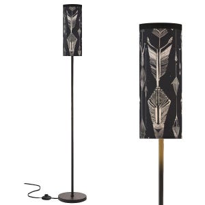 May include: A tall, black floor lamp with a cylindrical lampshade. The lampshade features a repeating pattern of white and gray feathers and geometric shapes against a black background. The lamp has a round base and a slender pole.