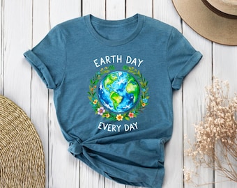 May include: A teal blue t-shirt with a white graphic of the Earth surrounded by flowers and the text "Earth Day Every Day".