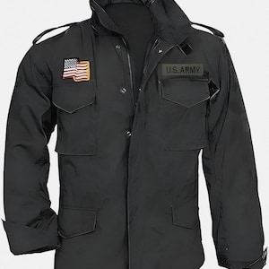 May include: Black military-style jacket with multiple pockets and a high collar. Features an American flag patch and a "U.S. ARMY" patch. The jacket has a zip closure and buttoned cuffs. A classic, durable outerwear piece.