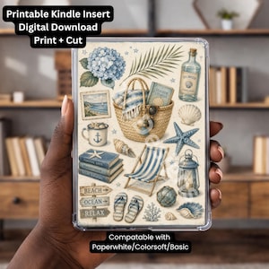May include: A Kindle insert with a beach theme, featuring illustrations of seashells, a beach chair, a basket, and a bottle. The insert includes the text "Printable Kindle Insert Digital Download Print + Cut".