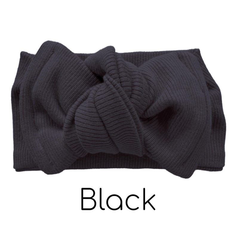 Pode incluir: Uma faixa de cabe&ccedil;a preta, canelada, com um detalhe de la&ccedil;o atado. A palavra "Black" est&aacute; impressa em uma fonte simples abaixo da faixa de cabe&ccedil;a. Este acess&oacute;rio foi projetado para ser usado ao redor da cabe&ccedil;a.