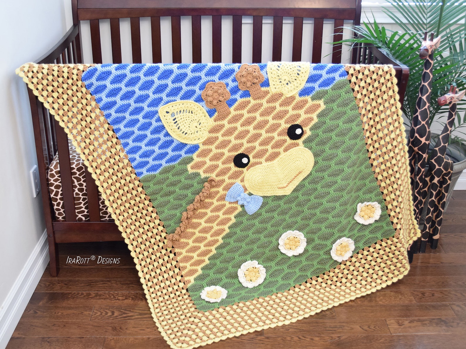 Crocheted giraffe baby blanket with 3D flowers and safari-themed scenery in blue, green, and yellow