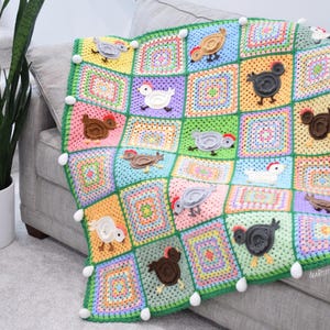 May include: A colourful crocheted blanket featuring a repeating pattern of chickens in various colours. The blanket is made with a variety of stitches and textures, and it has a soft, fluffy feel. The blanket is perfect for adding a touch of whimsy to any room.