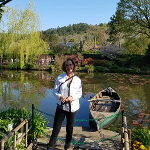 a woman standing on a dock next to a boat