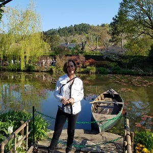 a woman standing on a dock next to a boat