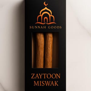 May include: Black box with a window displaying two brown Zaytoon Miswak sticks. The box has the words "SUNNAH GOODS" and "ZAYTOON MISWAK" in orange. The top of the box features an orange mosque design.