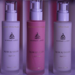 May include: Three bottles of Sunnah Goods Musk Al-Tahara. The bottles are white, pink, and off-white, each with a different scent: Classic White Musk, Pomegranate Musk, and Saffron Musk. Each bottle has a pump dispenser and a gold logo with Arabic text.