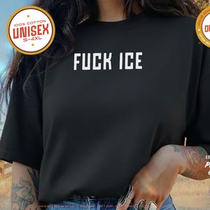 Anti-ICE protest shirt that says “FUCK ICE” in bold white text on a vintage Pepper color t-shirt. Graphic is clean and strong with all-caps block letters centered on chest. Designed for protests and progressive voices. Available in unisex sizing S–4XL. Soft ring-spun cotton, fast shipping, and machine washable.