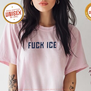 Anti-ICE protest shirt that says “FUCK ICE” in bold white text on a vintage Pepper color t-shirt. Graphic is clean and strong with all-caps block letters centered on chest. Designed for protests and progressive voices. Available in unisex sizing S–4XL. Soft ring-spun cotton, fast shipping, and machine washable.