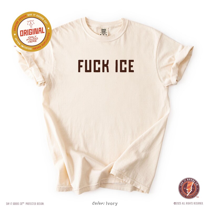 May include: Ivory-colored t-shirt with the text "FUCK ICE" in dark brown block letters. The shirt has a crew neck and short sleeves. The image also includes the text "ORIGINAL" and "SAY IT GOODS CO." on the shirt.