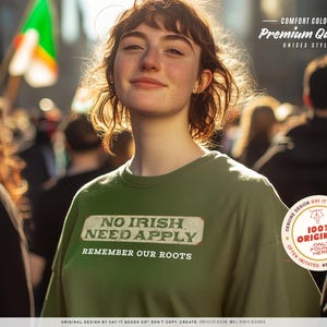 Graphic tee featuring the phrase “No Irish Need Apply” with “Remember Our Roots” printed beneath in bold white lettering. A vintage, historical design on a Comfort Colors® cotton shirt, perfect for Irish Americans, history buffs, educators, and those honoring immigrant heritage. Ideal for St. Patrick’s Day, cultural pride, or anti-discrimination messaging. Available in unisex sizing.
