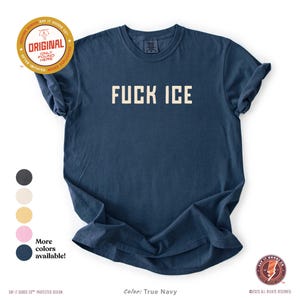 May include: True navy blue t-shirt with the text "FUCK ICE" in a bold, white, block font. The shirt has a crew neck and short sleeves. Additional colors are available. The shirt has a vintage look.