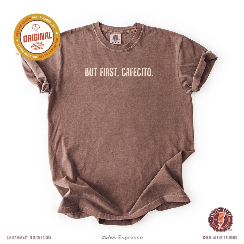 Minimalist “But First. Cafecito.” graphic tee in espresso brown featuring cream typography. Latina coffee lover shirt celebrating Hispanic culture and morning cafecito ritual. Modern unisex coffee shirt perfect for espresso lovers, brunch outfits, and gift ideas for moms, sisters, and café fans.