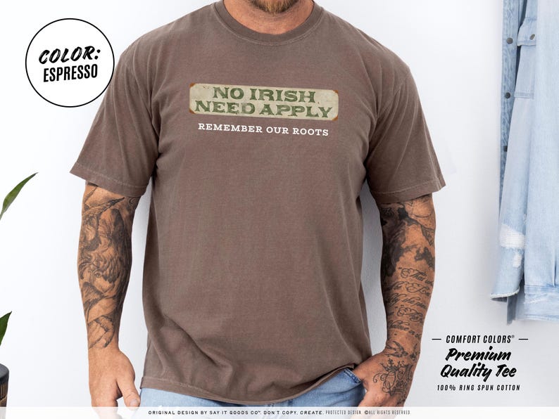 Graphic tee featuring the phrase “No Irish Need Apply” with “Remember Our Roots” printed beneath in bold white lettering. A vintage, historical design on a Comfort Colors® cotton shirt, perfect for Irish Americans, history buffs, educators, and those honoring immigrant heritage. Ideal for St. Patrick’s Day, cultural pride, or anti-discrimination messaging. Available in unisex sizing.