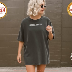 Minimalist “But First. Cafecito.” graphic tee in espresso brown featuring cream typography. Latina coffee lover shirt celebrating Hispanic culture and morning cafecito ritual. Modern unisex coffee shirt perfect for espresso lovers, brunch outfits, and gift ideas for moms, sisters, and café fans.