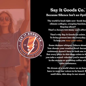 May include: A black and red logo with the text "Say It Goods Co. Wear Your Voice" and the tagline "Because Silence Isn't an Option". The text describes a company that makes clothing and accessories to encourage people to speak out about important issues.