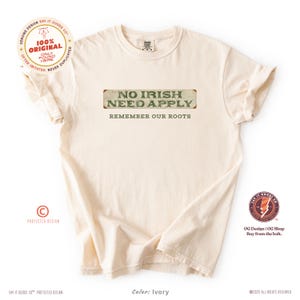 Graphic tee featuring the phrase “No Irish Need Apply” with “Remember Our Roots” printed beneath in bold white lettering. A vintage, historical design on a Comfort Colors® cotton shirt, perfect for Irish Americans, history buffs, educators, and those honoring immigrant heritage. Ideal for St. Patrick’s Day, cultural pride, or anti-discrimination messaging. Available in unisex sizing.