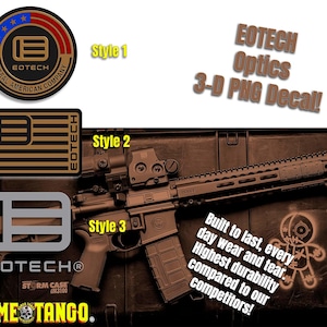May include: A brown and black EOTech optics decal with the text "EOTech Optics 3-D PNG Decal!"  The decal is shown on a brown wooden surface with a black rifle and a red and black sight. The rifle has a black magazine and a black handguard. The text "Built to last, every day wear and tear. Highest durability compared to our competitors!" is also visible on the surface.