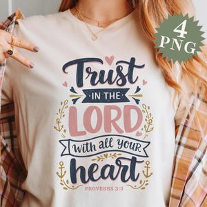 May include: A white t-shirt with a navy blue and pink graphic design that says "Trust in the Lord with all your heart" and "Proverbs 3:5".