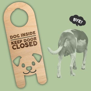 May include: Wooden door hanger with the text "DOG INSIDE KEEP DOOR CLOSED" and a dog face cutout. A dog with a white and brown coat is shown from the rear with a speech bubble that says "BYE!" on a green background.